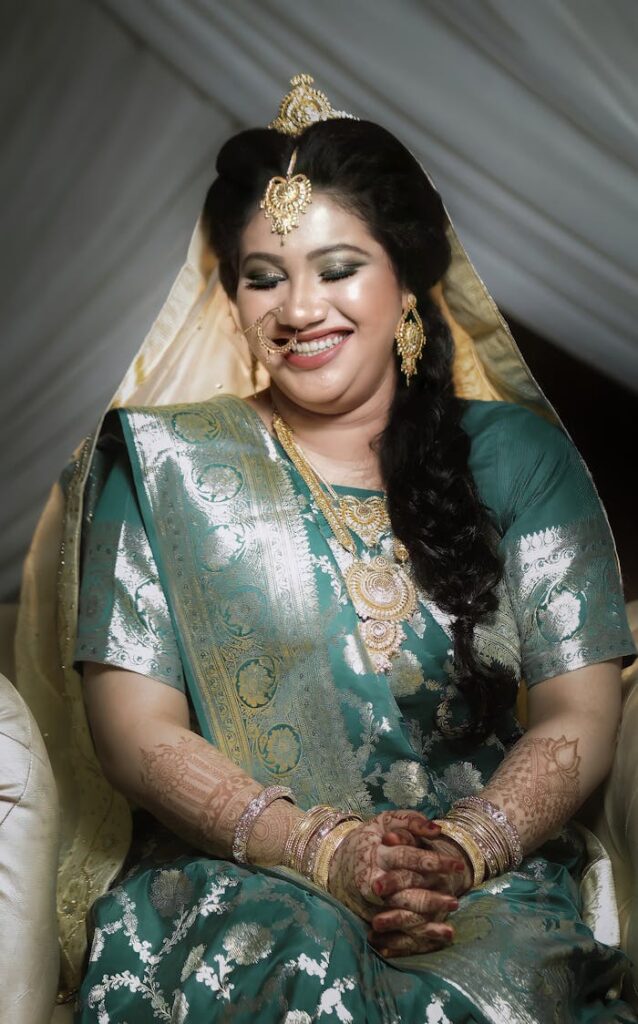 A Woman in Green and Gold Saree Smiling